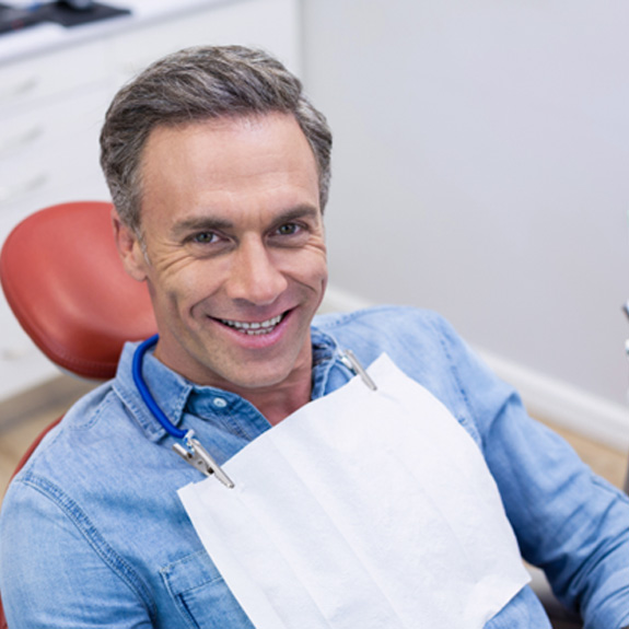 Man sitting in dental chair smiling