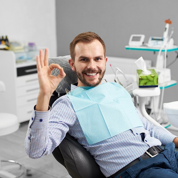 Male dental patient giving okay sign after smile makeover in Reynoldsburg