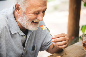 Senior man about to take a bite of food