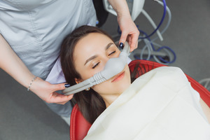 Placing mask on patient’s nose for nitrous oxide sedation
