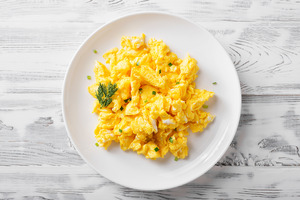Plate of scrambled eggs with garnish